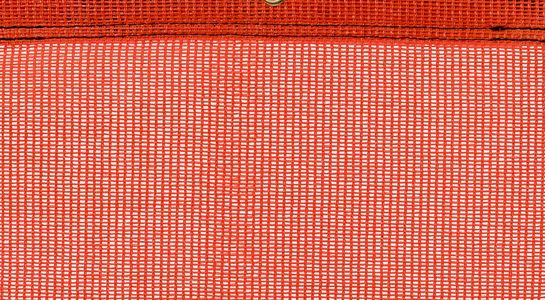 Detail picture of PE air permeable cover, 200 g, orange, with eyelet and border on top