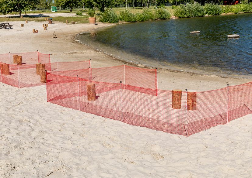 Red barrier fence on sand, 2 cubes, outside picture