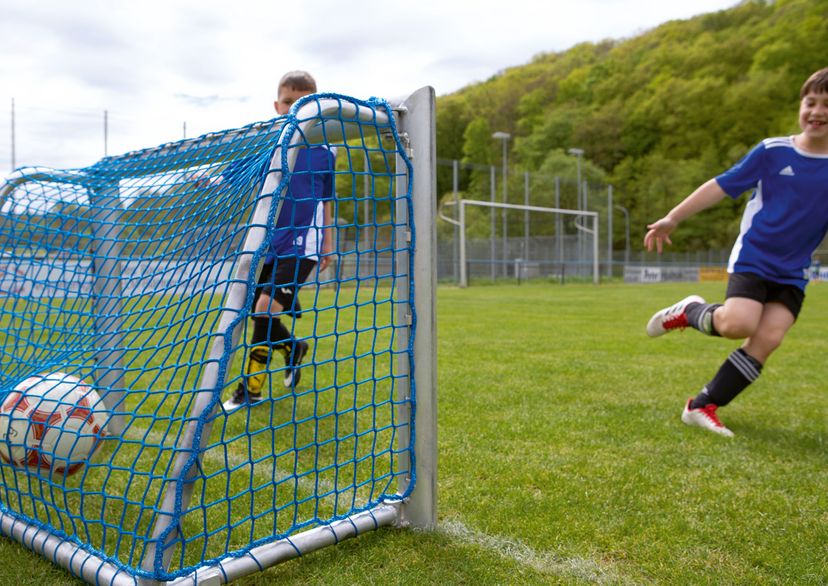 Mini football soccer goal net in blue with 2 kids playing